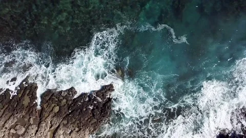 Video from drone of blue sea waves hitting the cliffs Stock Footage 211174292