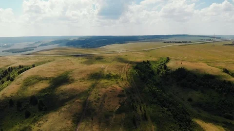 Video from a drone: flew over the summer fields and the hill. Stock Footage 106179320