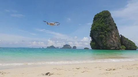Video of a drone flying on a beautiful sandy beach with an emerald sea Stock Footage 254429323