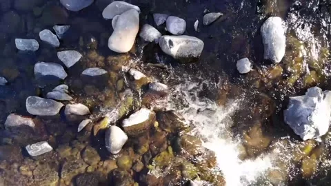 A video of a drone hovering over a fast flowing river Stock Footage 157455563