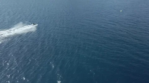 Video of a drone in motion towards jet skis doing circles in the Mediterranean Stock Footage 245729653