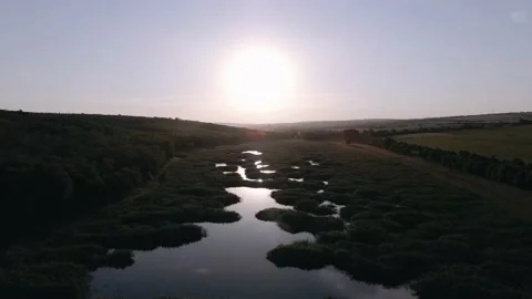 Video with drone over a river in the forest at sunset Stock Footage 140990482