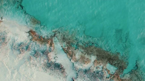 Video of drone views of a cliff next to a sea with crystal clear waters Stock Footage 233820711
