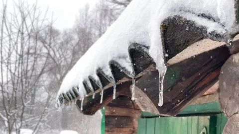 Video of dropping icicles on a warm spring day Stock Footage 245483371