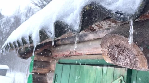 Video of dropping icicles on a warm spring day Stock Footage 245483423