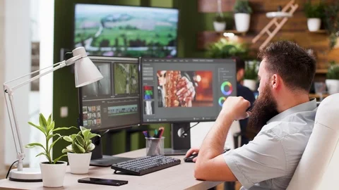 Video editor and colorist talking with his colleague Stock Footage 110477598