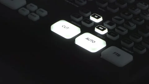 Video Editor Using Illuminated Editing Console in Low-Lit Studio Stock Footage 348125841