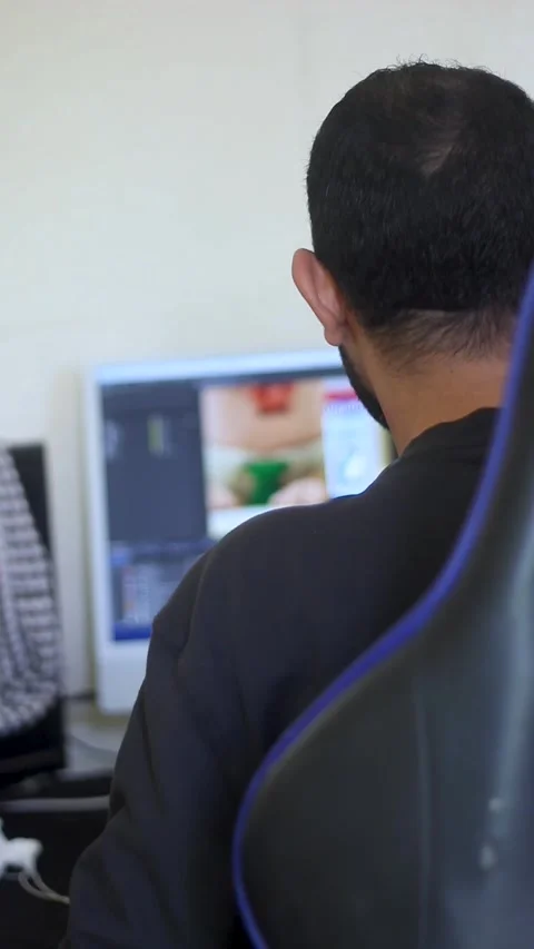 Video Editor Working on Editing Software Timeline on Computer in Modern Work Stock Footage 340294807