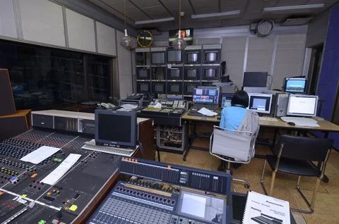 Video editor working with professional broadcasting equipment and audio mixer Stock Photos
