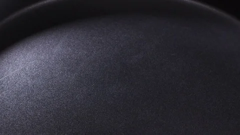 Video of egg being dropped on hot pan Stock Footage 72414972
