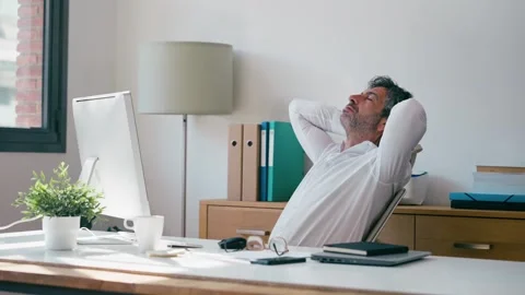 Video of exhausted businessman stretching while working on a computer in th.. Stock Footage 340829350