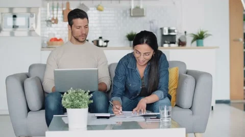 Video of exhausted couple using their laptop to consulting some invoices an.. Video stock 227887925