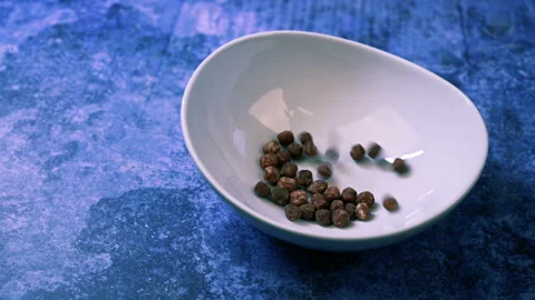 Video of falling chocolate cereal balls on white bowl. Stock Footage 172418579