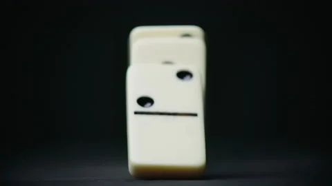 Video of falling defocused domino elements on black Stock Footage 153136205