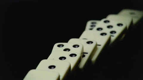 Video of falling domino elements - domino effect on black Stock Footage 153320279