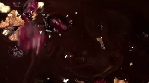 Video of falling nuts and cranberry in real slow motion Stock Footage 79566613