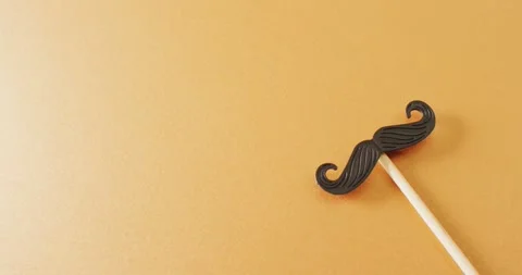 Video of false moustache on stick on yellow background with copy space Stock Footage 341560147