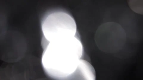 Video of a fast leak of bright white light on full-screen bokeh 스톡 동영상 317478935