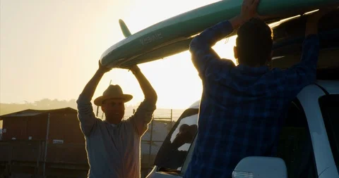 Video of father and son loading paddleboards on car. 스톡 동영상 88377686