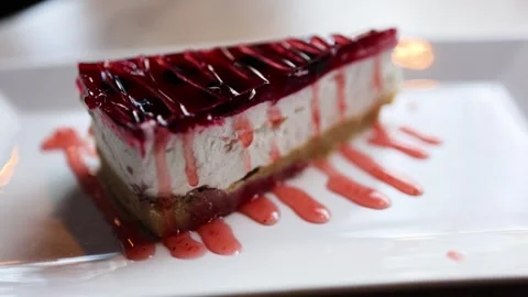The video features a decadent cheesecake adorned with a glossy red jelly Stock-Footage 266685622