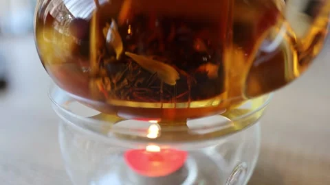 The video features tea leaves gracefully swirling in a teapot Stock Footage 265744921