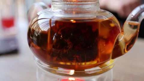 The video features tea leaves gracefully swirling in a teapot 库存影片 266327325