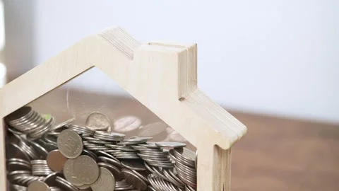 Video featuring coins being placed into a piggy bank Stock Footage 321949012