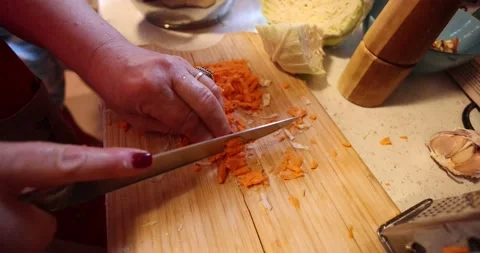 A video of female hands precisely slicing a fresh carrot Stock Footage 318954964