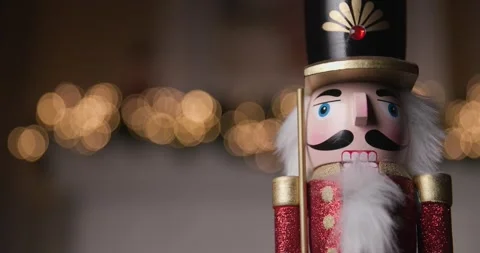 Video of festive Nutcracker figurine illuminated by golden bokeh lights, Stock Footage 287176986