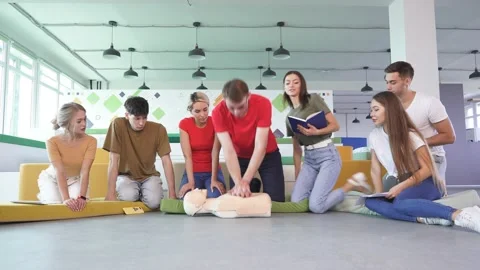Video of first aid help on mannequin, two people help as team, practice cpr. Stock Footage 144102991