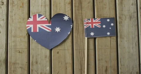Video of flags of australia in shape of heart and rectangle on wooden background Stock Footage 342232098