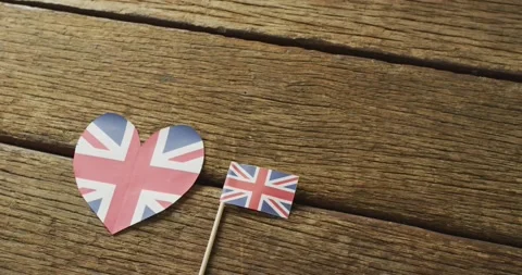 Video of flags of great britain in shape of heart and rectangle on wooden Stock Footage 195995216