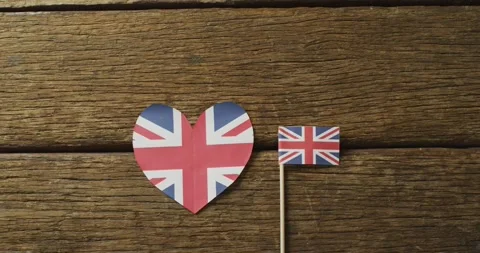 Video of flags of great britain in shape of heart and rectangle on wooden Stock Footage 338433802