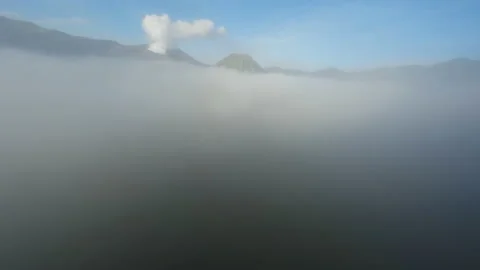 Video of flying through the fog in Java. Backdrop of volcanoes. Stock Footage 238858261