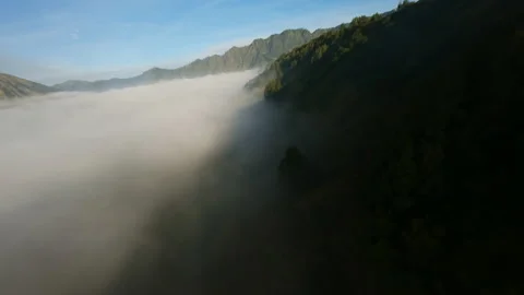 Video of flying through the fog in Java. Backdrop of volcanoes. Video stock 238859026