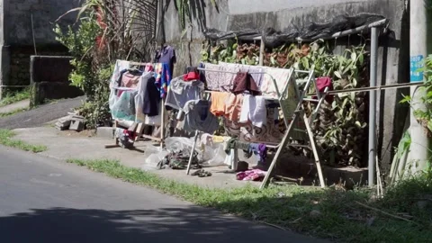 Video footage of drying clothes on the drier stand next to the road Stock Footage 154499438