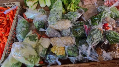 Video Fresh vegetables in plastic bags and baskets at a market stall Stock Footage 340048161