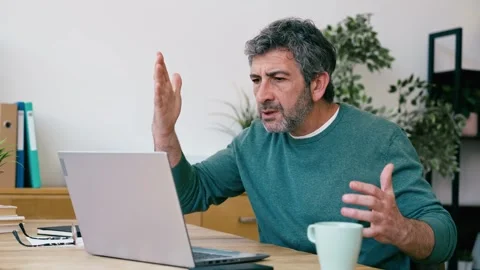 Video of frustrated man hitting his laptop while working in the office Stock Footage 340829302