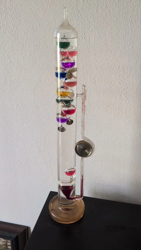 A video of a Galileo thermometer on a table, highlighting retro science Stock Footage 346259057