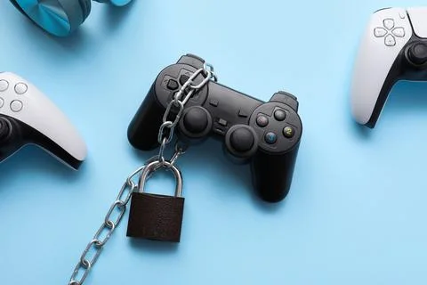 Video game addiction with chained controller, gaming dependency, and digital  Stock Photos