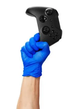 Video game console controller in gamer gloved hands. Games during isolation at Stock Photos