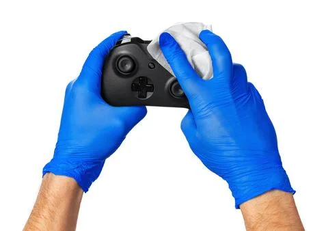 Video game console controller in gamer gloved hands. Games during isolation at Stock Photos