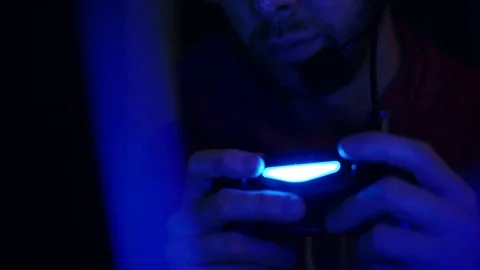 Video Game Controller 4K, Gamer Man With Headset Immersed In Online Co-op Gaming Stock Footage 87569285