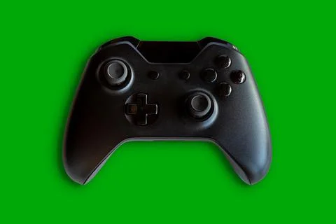 Video game controller and game controller. Green background. Selective focus Stock Photos