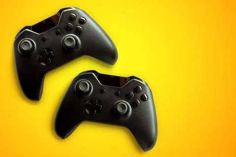 Video game controller and game controller. Orange background. Selective focus Stock Photos