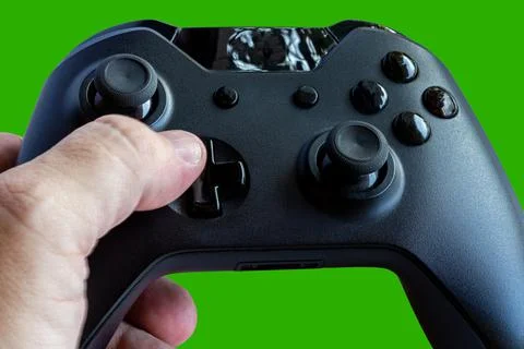Video game controller and game controller. Green background. Selective focus. Stock Photos