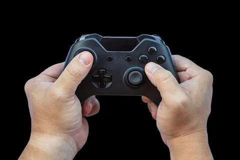 Video game controller and game controller. Black background. Selective focus. Stock Photos