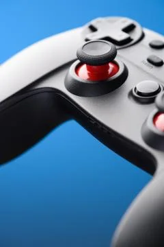 Video game controller. Game pad joystick closeup on blue background. Stock Photos