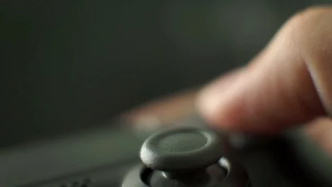 Video game playing focus on the controllers thumbstick close up shot Stock Footage 115932408