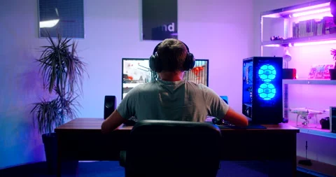 Video gamer playing call of duty warzone on his personal computer Stock Footage
